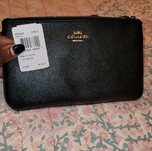 A black Coach wristlet